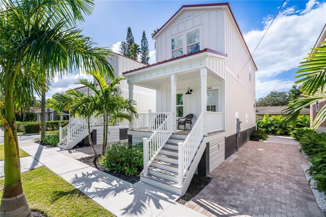 340 6th St E, Bradenton, FL 34208 - view of front of property featuring board and batten siding, a porch, and stairs