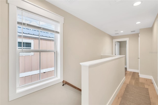 340 6th St E, Bradenton, FL 34208 - corridor featuring baseboards, light wood-style flooring, recessed lighting, and an upstairs landing