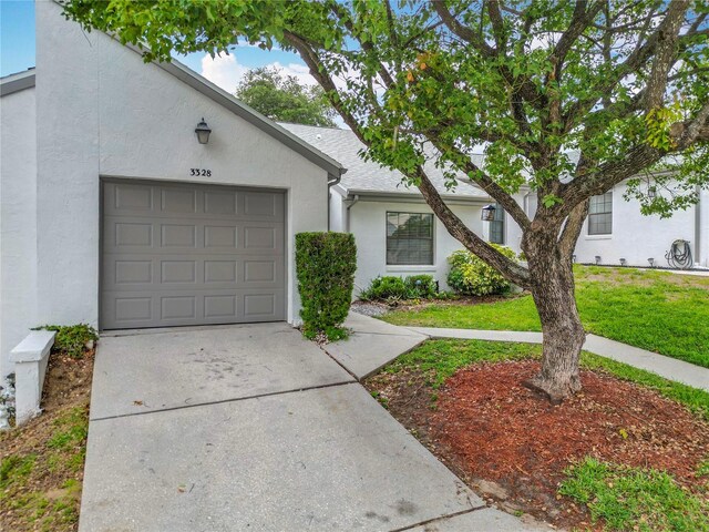 3328 S Whitechappel Pt, Inverness, FL 34452 - view of property featuring concrete driveway, stucco siding, a front lawn, and a garage