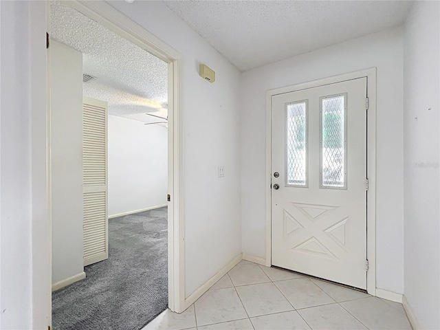 3328 S Whitechappel Pt, Inverness, FL 34452 - foyer featuring a textured ceiling, baseboards, and light tile patterned flooring