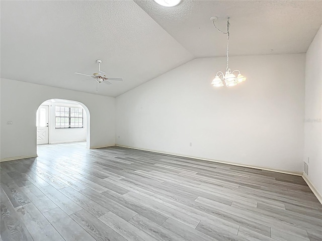3328 S Whitechappel Pt, Inverness, FL 34452 - spare room with a ceiling fan, arched walkways, lofted ceiling, a textured ceiling, and light wood-type flooring