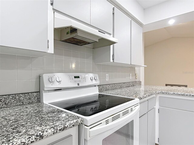 3328 S Whitechappel Pt, Inverness, FL 34452 - kitchen featuring white range with electric cooktop, under cabinet range hood, decorative backsplash, white cabinets, and lofted ceiling