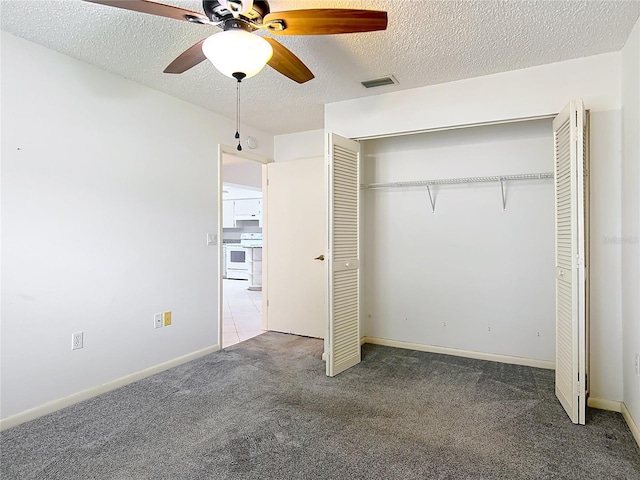 3328 S Whitechappel Pt, Inverness, FL 34452 - unfurnished bedroom with carpet flooring, a textured ceiling, a closet, ceiling fan, and baseboards