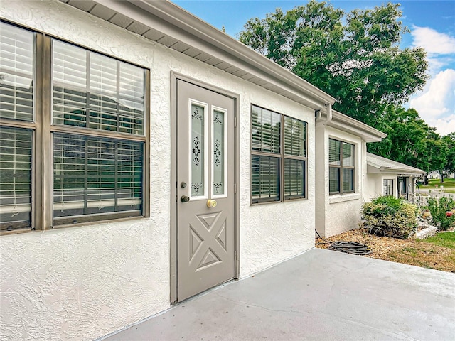 3328 S Whitechappel Pt, Inverness, FL 34452 - property entrance with stucco siding and a patio