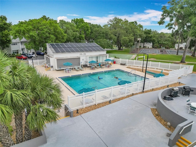 3328 S Whitechappel Pt, Inverness, FL 34452 - community pool with a patio area, a fenced backyard, and view of wooded area