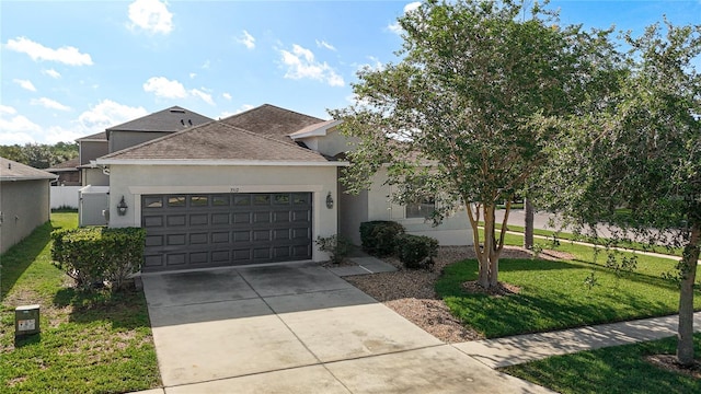 3512 Gerrads Cross Ct, Land O Lakes, FL 34638 - view of front of home with stucco siding, a garage, roof with shingles, and a front lawn