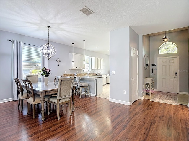 3512 Gerrads Cross Ct, Land O Lakes, FL 34638 - dining space with dark wood-style floors, a chandelier, and plenty of natural light