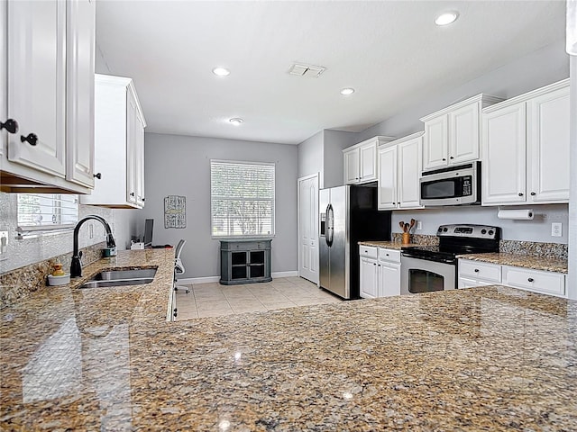 3512 Gerrads Cross Ct, Land O Lakes, FL 34638 - kitchen featuring appliances with stainless steel finishes, white cabinetry, stone counters, and recessed lighting