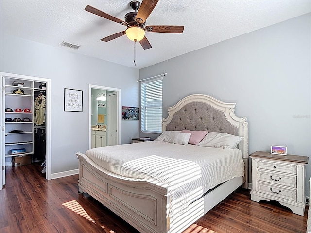 3512 Gerrads Cross Ct, Land O Lakes, FL 34638 - bedroom featuring a spacious closet, wood finished floors, a closet, connected bathroom, and a ceiling fan