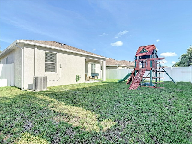 3512 Gerrads Cross Ct, Land O Lakes, FL 34638 - back of house with a playground, a fenced backyard, and stucco siding