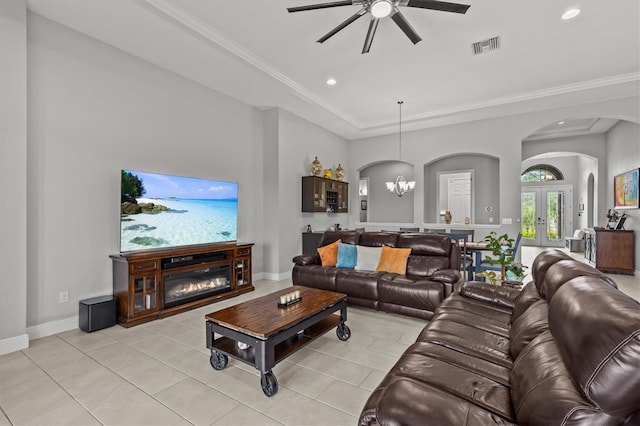 living room with arched walkways, ceiling fan, recessed lighting, a glass covered fireplace, and light tile patterned floors