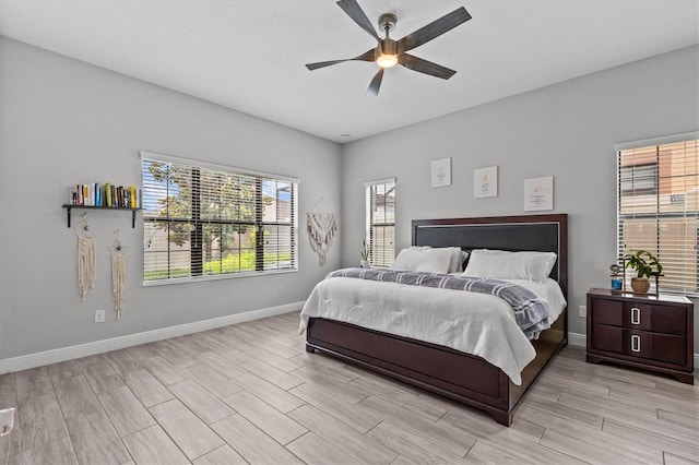 bedroom featuring light wood-style floors, baseboards, and a ceiling fan