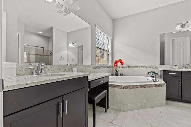 full bathroom with a bath, tile patterned floors, a shower stall, and two vanities