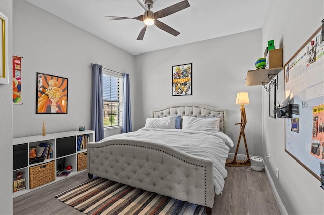 bedroom with wood finished floors, baseboards, and ceiling fan