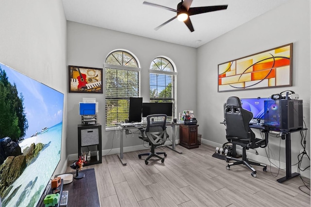 office featuring a ceiling fan, wood finished floors, and baseboards