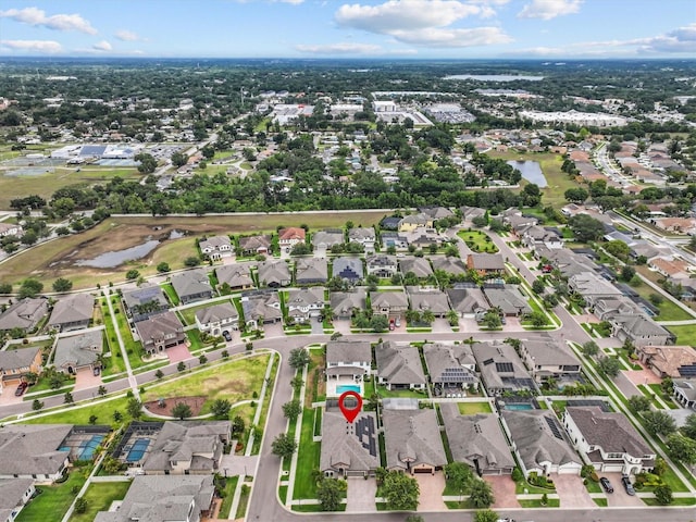 aerial overview of property's location featuring nearby suburban area and a large body of water