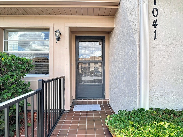 doorway to property with stucco siding