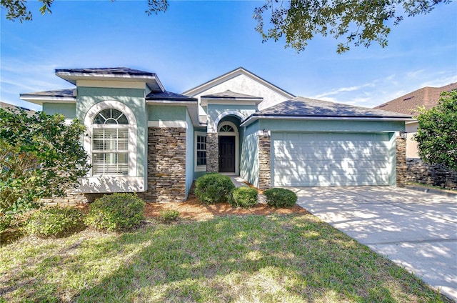 11567 Weston Course Loop, Riverview, FL 33579 - view of front of house with a garage, stucco siding, concrete driveway, and stone siding