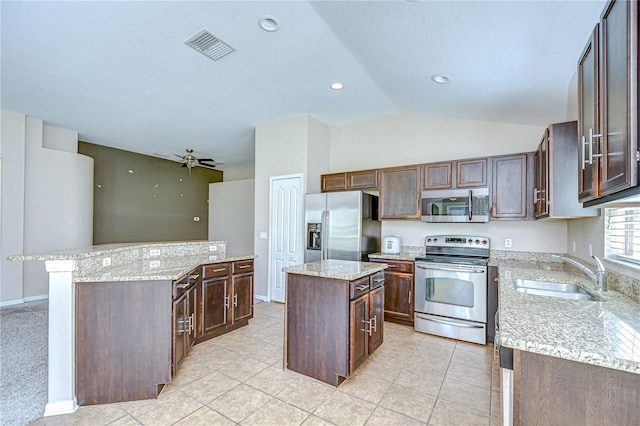 11567 Weston Course Loop, Riverview, FL 33579 - kitchen with appliances with stainless steel finishes, a center island, a sink, a ceiling fan, and vaulted ceiling