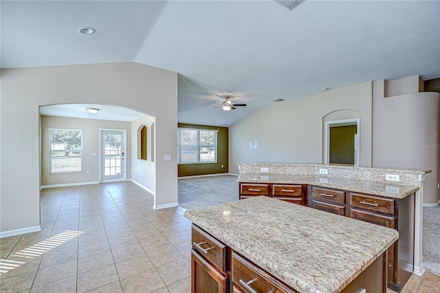 11567 Weston Course Loop, Riverview, FL 33579 - kitchen featuring a center island, arched walkways, open floor plan, ceiling fan, and lofted ceiling
