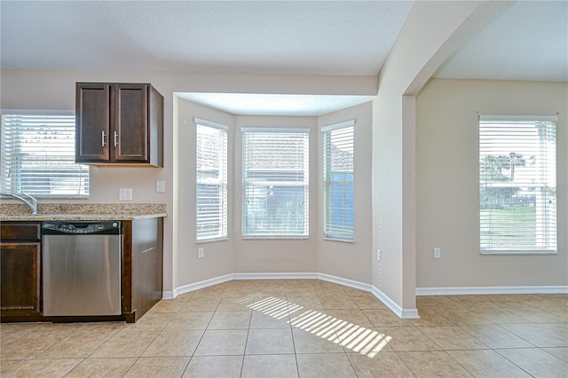 11567 Weston Course Loop, Riverview, FL 33579 - kitchen with dishwasher, dark brown cabinetry, light tile patterned flooring, and baseboards