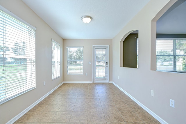 11567 Weston Course Loop, Riverview, FL 33579 - unfurnished room with plenty of natural light, baseboards, and light tile patterned floors