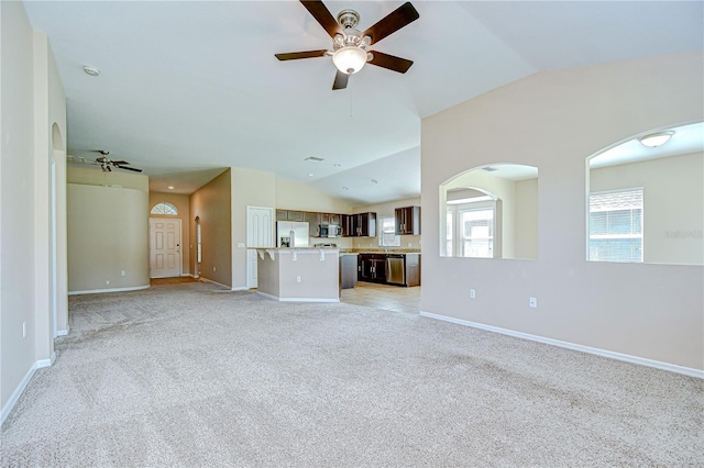 11567 Weston Course Loop, Riverview, FL 33579 - unfurnished living room with ceiling fan, lofted ceiling, light carpet, baseboards, and arched walkways