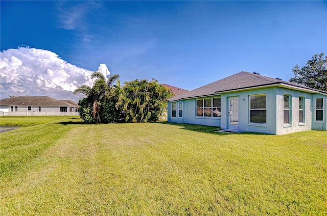 11567 Weston Course Loop, Riverview, FL 33579 - back of house featuring stucco siding and roof with shingles