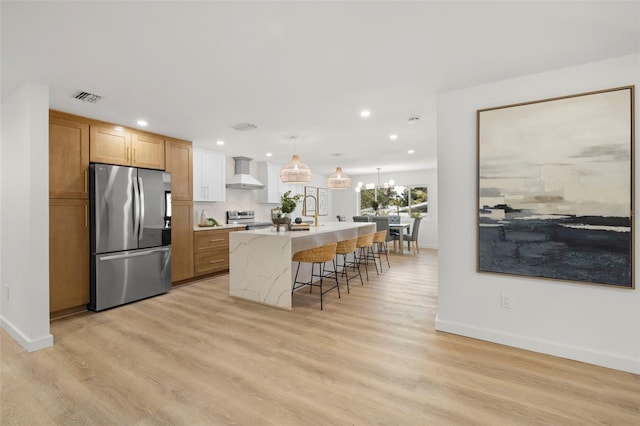 3801 Dr Martin Luther King Jr St N, Saint Petersburg, FL 33703 - kitchen with stainless steel appliances, wall chimney range hood, baseboards, recessed lighting, and a center island with sink