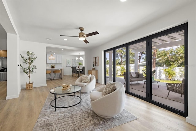 3801 Dr Martin Luther King Jr St N, Saint Petersburg, FL 33703 - living area featuring light wood-style floors, ceiling fan, recessed lighting, baseboards, and a chandelier