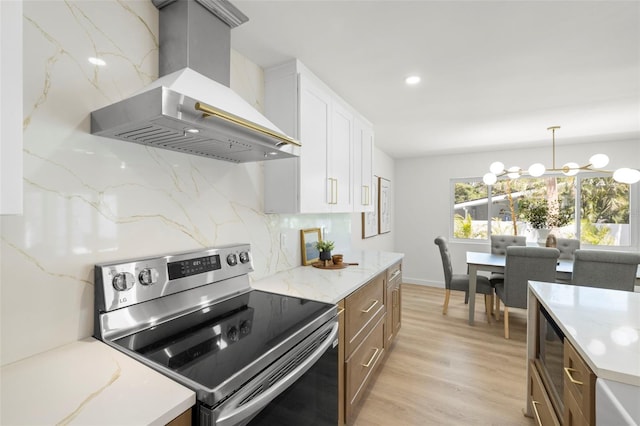 3801 Dr Martin Luther King Jr St N, Saint Petersburg, FL 33703 - kitchen with electric stove, wall chimney range hood, decorative backsplash, light wood-style flooring, and a chandelier