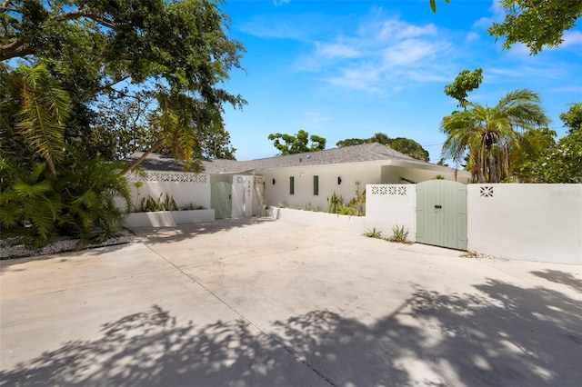 3801 Dr Martin Luther King Jr St N, Saint Petersburg, FL 33703 - view of front of property featuring a gate, stucco siding, and concrete driveway