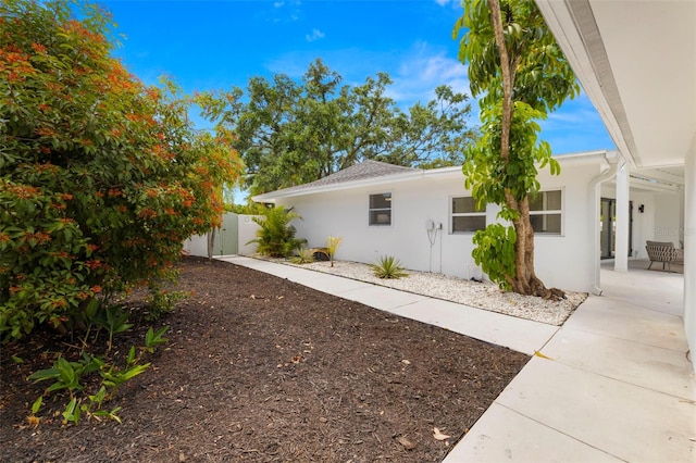 3801 Dr Martin Luther King Jr St N, Saint Petersburg, FL 33703 - view of home's exterior featuring stucco siding, fence, and a gate