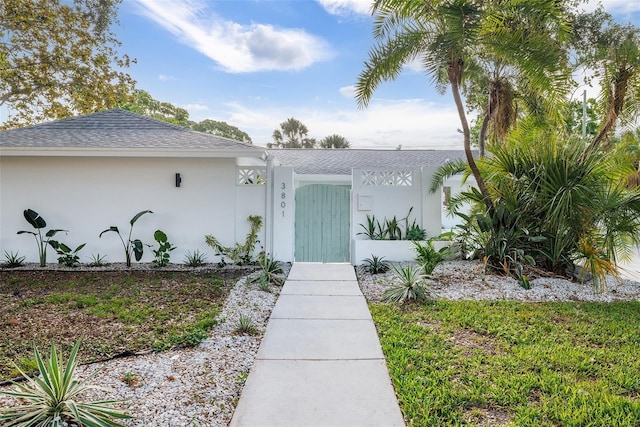 3801 Dr Martin Luther King Jr St N, Saint Petersburg, FL 33703 - view of front of house featuring roof with shingles and stucco siding