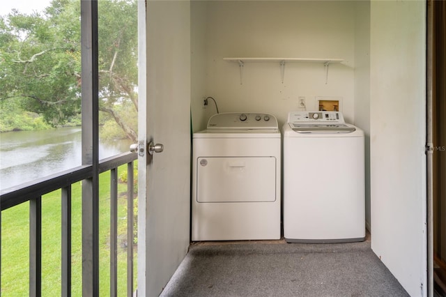 210 Cypress Ct Unit 122, Oldsmar, FL 34677 - laundry area featuring independent washer and dryer, a water view, plenty of natural light, and carpet floors