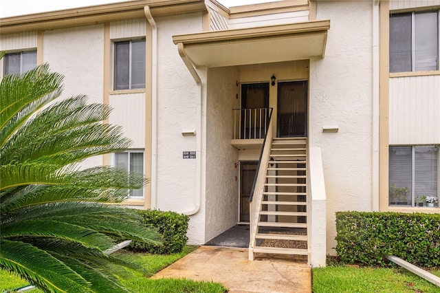 210 Cypress Ct Unit 122, Oldsmar, FL 34677 - doorway to property featuring stucco siding