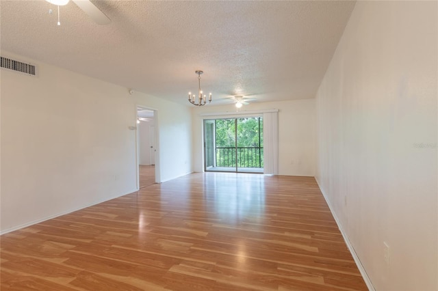 210 Cypress Ct Unit 122, Oldsmar, FL 34677 - unfurnished room with a textured ceiling, a chandelier, light wood-style floors, and ceiling fan