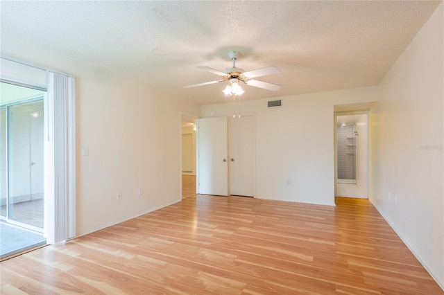 210 Cypress Ct Unit 122, Oldsmar, FL 34677 - empty room featuring light wood finished floors, ceiling fan, and a textured ceiling
