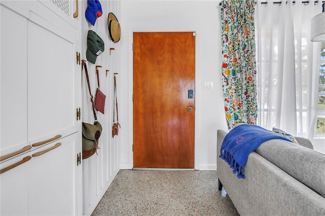 11376 119th Ter, Largo, FL 33778 - entryway with dark aggregate flooring and baseboards