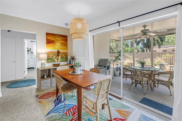 11376 119th Ter, Largo, FL 33778 - dining space featuring speckle patterned floor, a ceiling fan, healthy amount of natural light, and a wainscoted wall