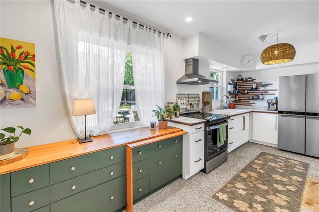 11376 119th Ter, Largo, FL 33778 - kitchen featuring freestanding refrigerator, wall chimney range hood, range with electric cooktop, a sink, and healthy amount of natural light