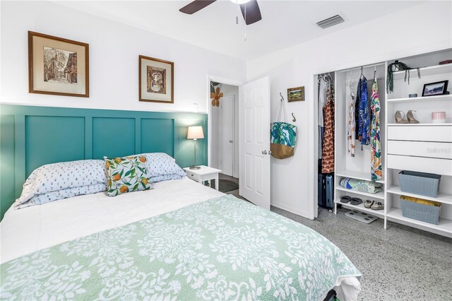 11376 119th Ter, Largo, FL 33778 - bedroom with speckle patterned floor, a closet, a ceiling fan, a wainscoted wall, and a decorative wall