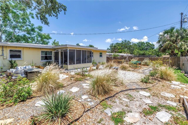 11376 119th Ter, Largo, FL 33778 - rear view of property with a sunroom, a fenced backyard, and stucco siding