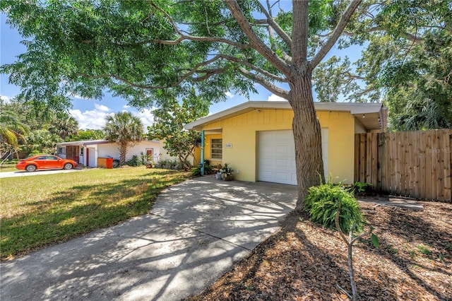 11376 119th Ter, Largo, FL 33778 - view of front of home featuring stucco siding, concrete driveway, and a garage