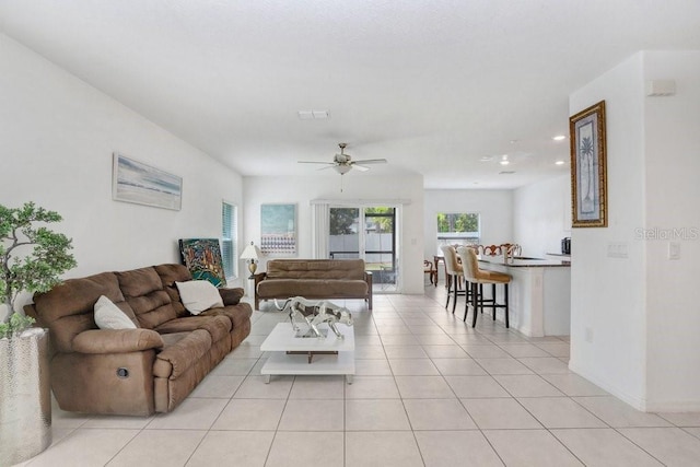 living room featuring a ceiling fan, light tile patterned flooring, recessed lighting, and baseboards