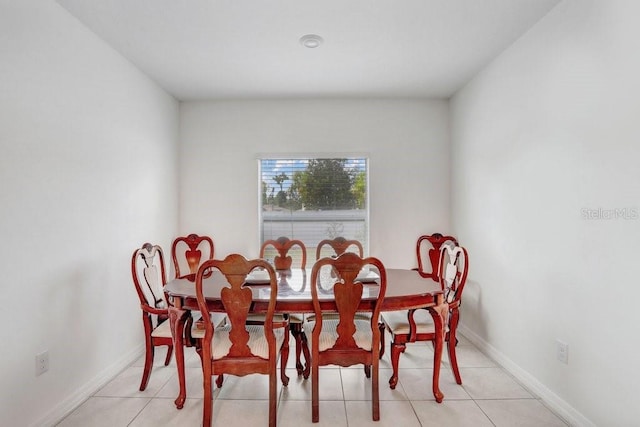 dining area with light tile patterned floors and baseboards