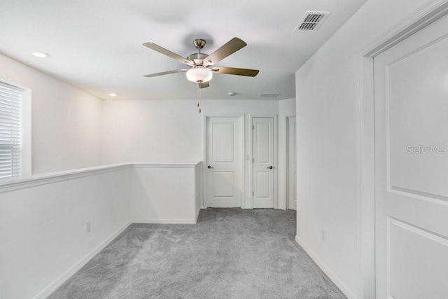 carpeted spare room featuring a ceiling fan, baseboards, and recessed lighting