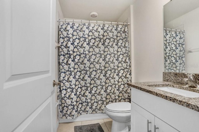 bathroom featuring toilet, tile patterned flooring, vanity, and a shower with shower curtain