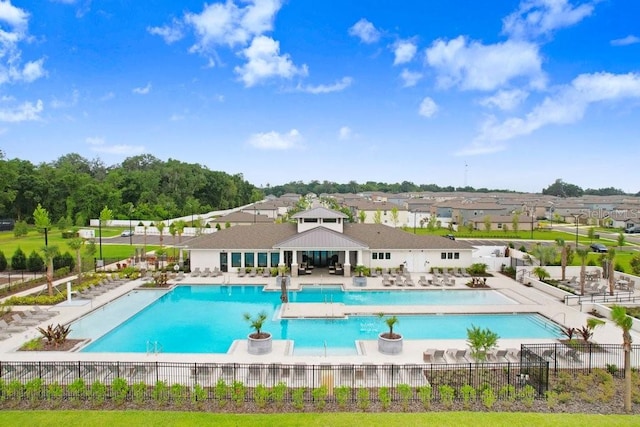 community pool with fence, a patio area, a residential view, and a gazebo