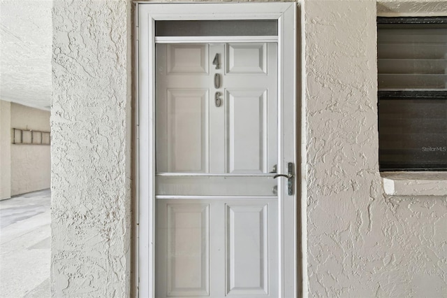 200 1st Ave Unit 406, St Pete Beach, FL 33706 - view of exterior entry featuring stucco siding